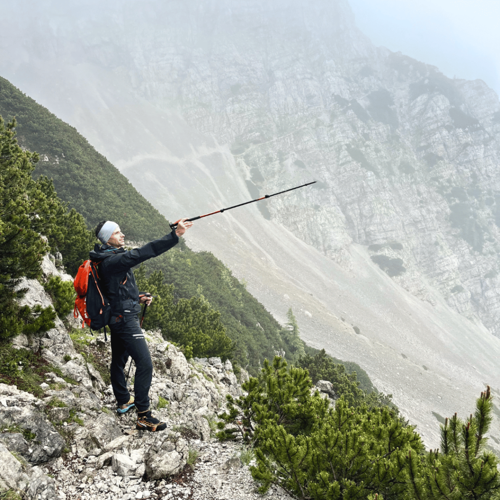 Hiker on a roky trail in Slovenia's Karawanks mountains 