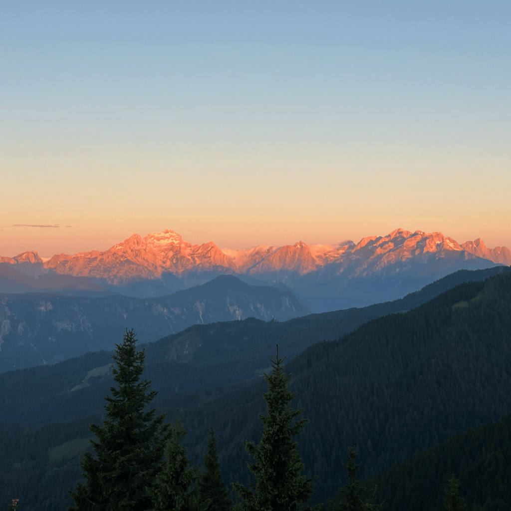 Sunset view from the Karavanke ridge with glowing light over the Julian Alps.
